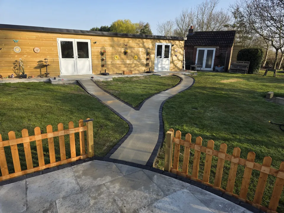 Curved garden paths leading to a timber-clad building